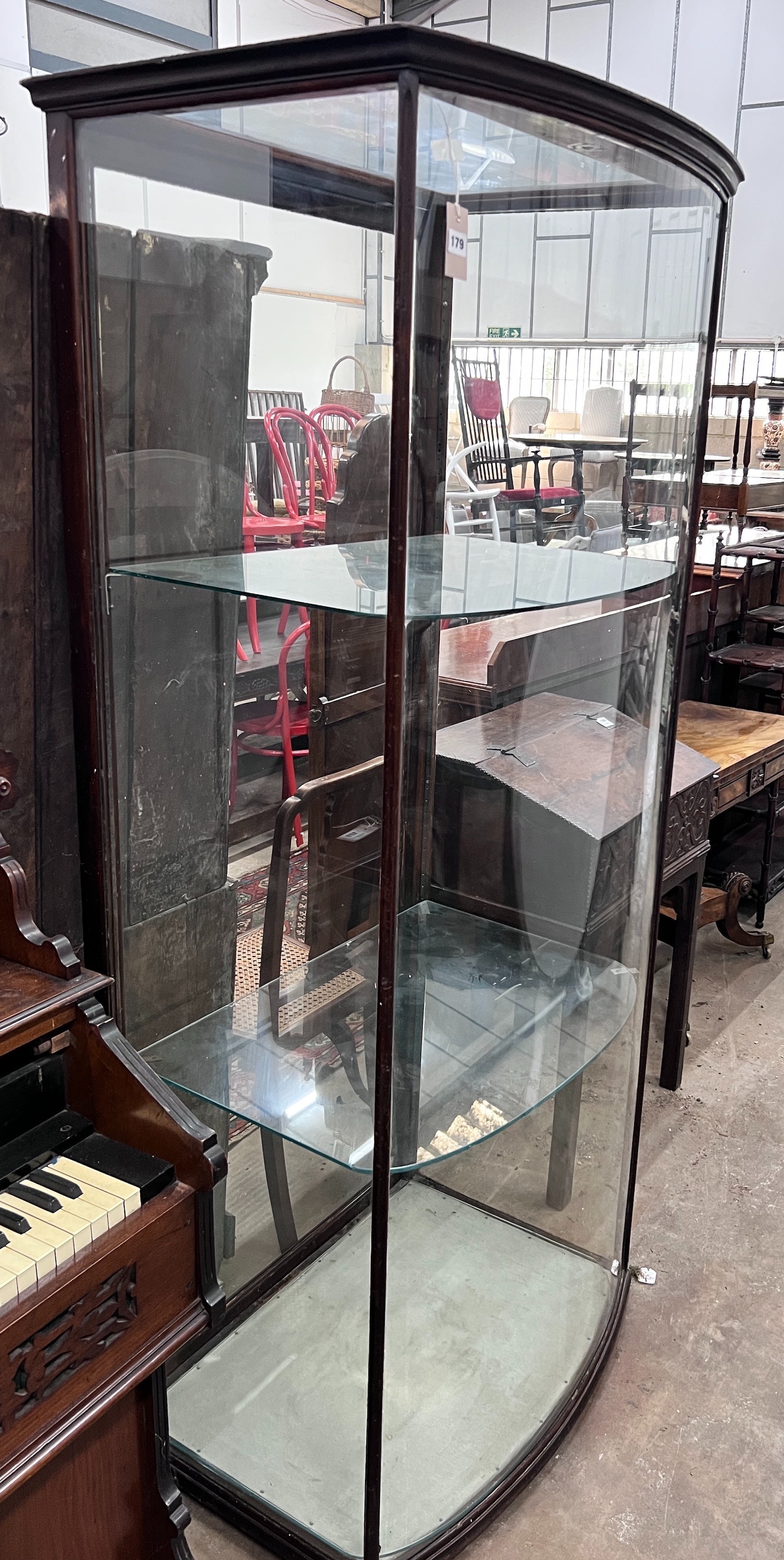 A late Victorian mahogany bowfront shop display cabinet, width 84cm, depth 58cm, height 196cm *Please note the sale commences at 9am.